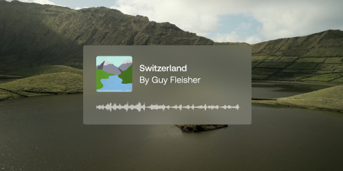 A lake, offset with a lush mountainous landscape.